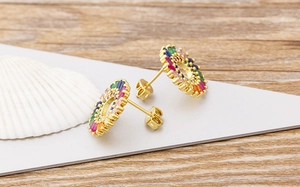 Detail of 18k gold plated sunflower stud earrings with colorful zircon stones
