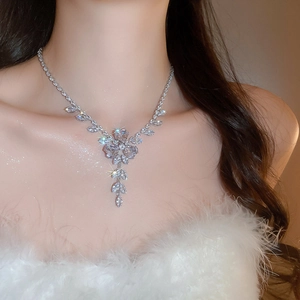 Close-up of a zircon floral tassel necklace on a model for elegant wedding style