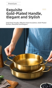 Polished gold stainless steel pan with solid dual handles in a modern kitchen setting