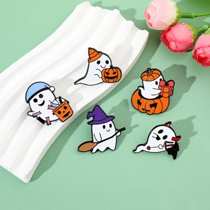 Close-up of five colorful Halloween enamel pins with ghosts and pumpkins on a white stand