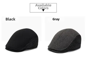 Detail view of winter flat cap for men in black and grey knitted textured fabric