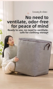 Detail of houndstooth storage bag with side handle and zipper closure for home organization