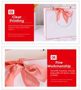 Detail of white gift paper bag with a pink silk bow and braided handle on marble