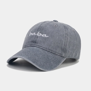 Detail of embroidered BABA logo on washed dark grey cotton twill baseball cap