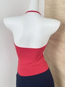 Detailed back view of a red halter neck top featuring an open back design on a mannequin