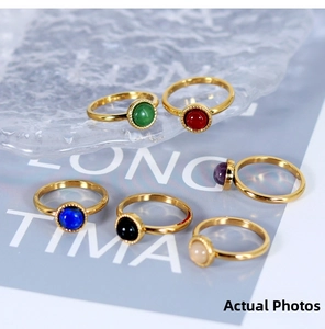 Detail of 18K gold-plated titanium rings with colorful natural stones and bead edging