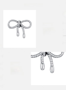 Macro detail of a 925 sterling silver bow earring with textured rope design and polished finish