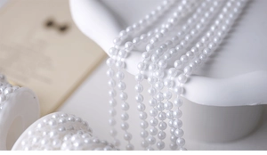 Macro view of white pearl bead chains for vintage jewelry making and Christmas decorations