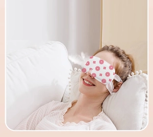 Close-up of model wearing disposable steam eye mask with pink daisy print for relaxation