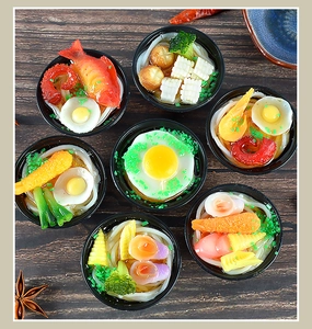 Detailed macro view of various miniature Japanese ramen and udon noodle bowls in wood setting