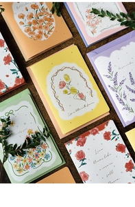 Detailed flat lay of colorful 3D pop-up flower greeting cards with artistic floral designs