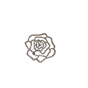 Elegant gold plated rose flower brooch with cubic zirconia crystals on white background