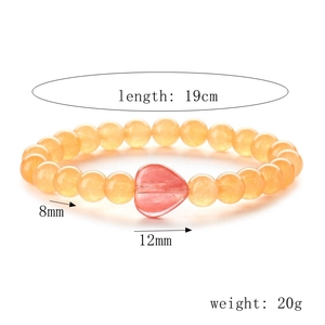 Detail view of 19cm agate bracelet with 8mm yellow beads and a 12mm pink heart charm