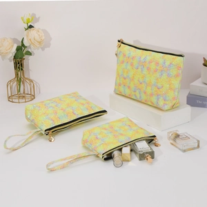 Three-piece set of holographic glitter makeup bags with gold zippers and handles
