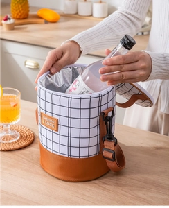 Detail of cylindrical insulated lunch bag with foil lining showing bottle capacity