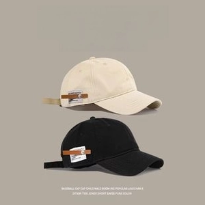 Detailed side view of cotton sun visors with premium leather buckle and woven labels