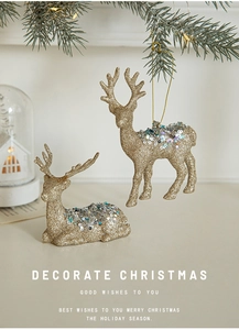 Detail of glittery gold reindeer ornaments with sequins on a decorated Christmas tree