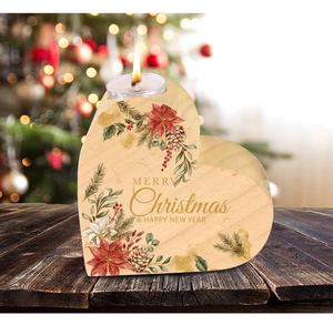 Detail of wooden heart-shaped candle holder with Merry Christmas pine cone print