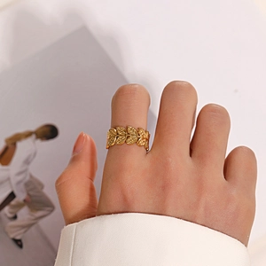 Elegant gold leaf adjustable titanium steel ring shown on finger with vintage style