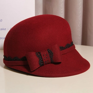 Close-up of wool felt riding hat with black lace, ribbon bow, and colorful rhinestones