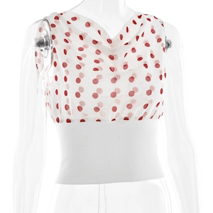 Detailed macro view of polka dot pattern on the sheer fabric of the cropped slim sleeveless top