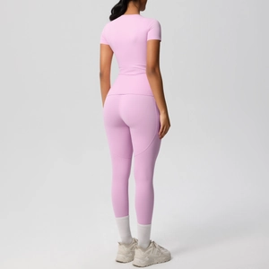Back view of a slim fit pink yoga set including short sleeve t-shirt and high waist leggings