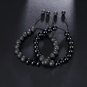 Close-up of 8mm natural tiger eye and lava stone beaded bracelets with woven adjustable cord