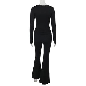 Detail view of the lace trim neckline and back cut of this black casual two-piece suit set