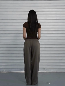 Back view of slim fit brown short sleeve top and olive wide leg pants for women