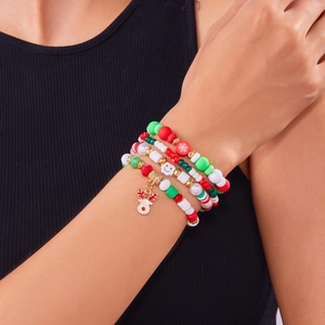 Close-up of a 4-piece Christmas beaded bracelet set with Santa and reindeer charms