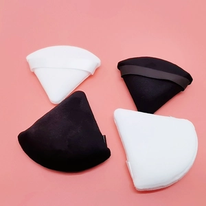 Set of four velvet triangular powder puffs in black and white with satin ribbon handles