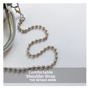 Detail of silver ball chain strap with metallic luster and secure lobster clasp