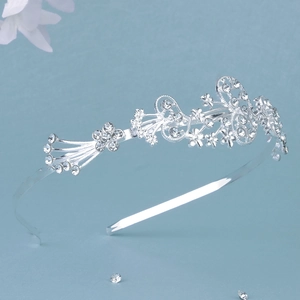 Close-up of sparkling rhinestones and floral alloy metal on a silver crown headband