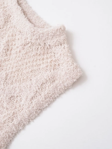 Detailaufnahme von weichem, hellrosa Strickstoff mit flauschiger Textur und feinen Nähten