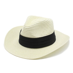 Close-up of beige straw Panama hat featuring a decorative wide black pleated fabric band