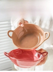 Detail of pink and brown ceramic double-handle bowls with polished underglaze finish