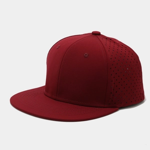Close-up of laser-cut ventilation holes on a dark red flat-brimmed hip-hop baseball cap