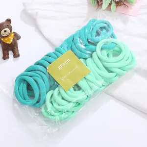 Detail view of seamless green elastic hair bands in multi-tone nylon fabric sets