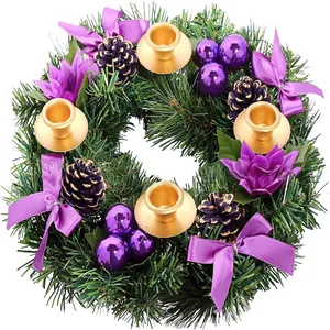 Purple festive Christmas wreath with pine cones, bows and four gold candle holders