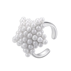 Detailed view of silver open ring featuring star shape cluster of white pearls