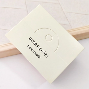 Close-up of cream jewelry display card with hand made accessories text engraving