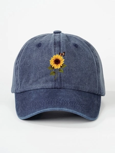 Close-up of sunflower and butterfly embroidery on washed blue denim baseball cap