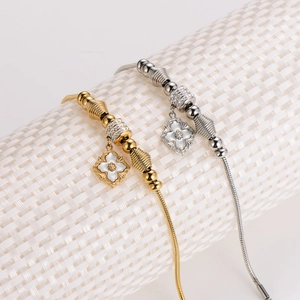 Elegant gold and silver snake chain bracelets with floral charms and pearl inlays