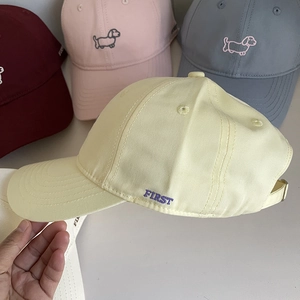 Detailed close-up of colorful cotton baseball caps featuring delicate puppy embroidery