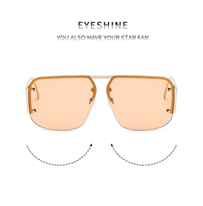 Detailed macro view of orange lenses and golden metal frame with decorative rivets