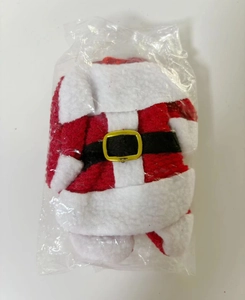 Detailed view of red and white plush Christmas napkin rings in protective packaging