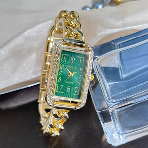 Detailed macro view of the rectangular diamond bezel and deep green watch face