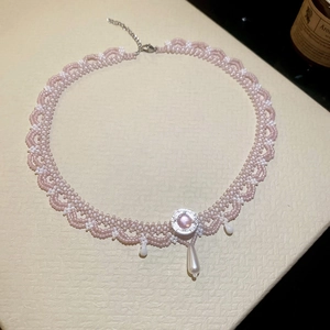 Detailed view of handmade pink crystal beaded choker with white teardrop pearl charms