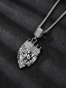 Detailed close-up of a silver lion head pendant with a diamond-encrusted crown and woven chain
