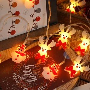 Detail view of snowman and elk LED Christmas string lights with warm yellow festive glow